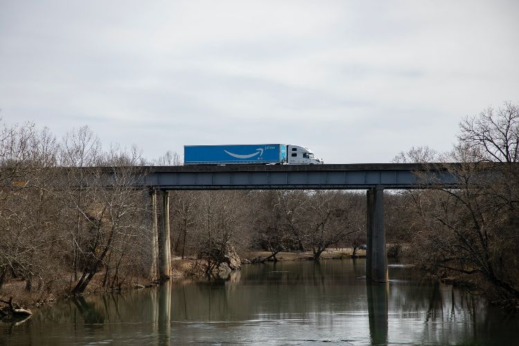 blue amazon truck crossing bridge