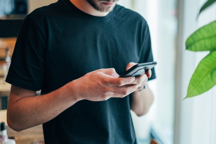 man using his smartphone