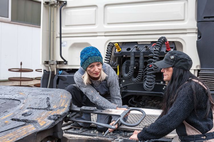 women fixing truck
