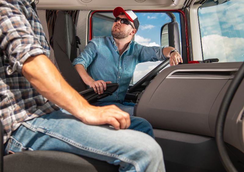 two truck drivers inside truck