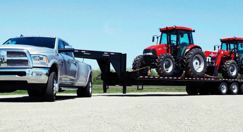 hotshot truck hauling farm equipment