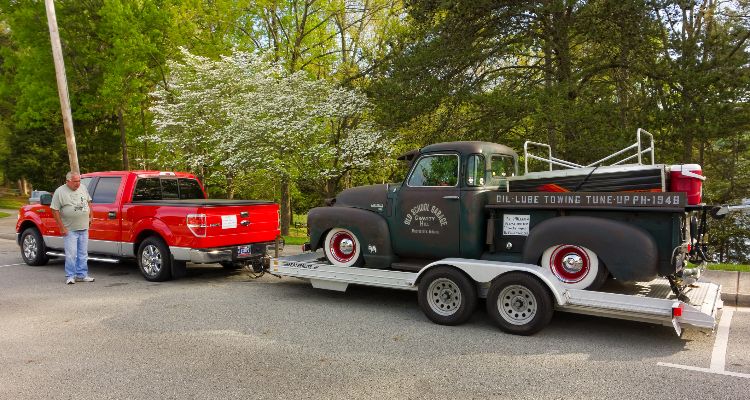 pickup truck towing vintage vehicle